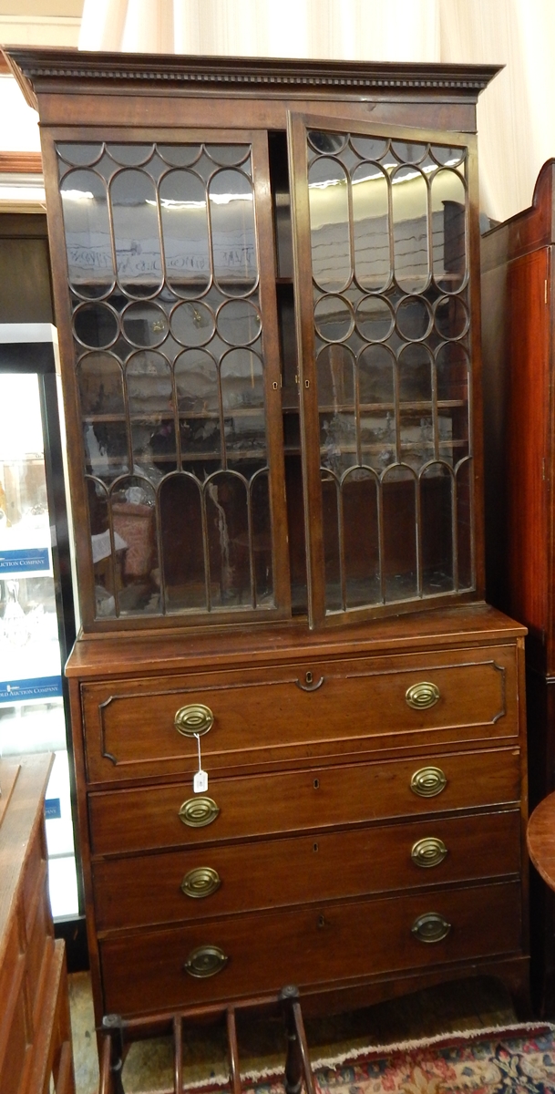 Georgian secretaire bookcase with stepped and dentil cornice, astragal-glazed panel doors,