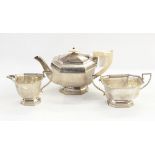 Silver three-piece teaset by Viners Limited, Sheffield 1939 of octagonal panelled form,