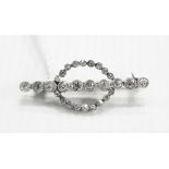 Early 20th century diamond bar brooch set with 10 Swiss cut diamonds to centre bar and surrounded