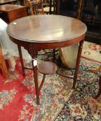 Mahogany circular occasional table on fluted legs with circular undershelf,