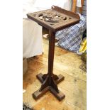 Stained oak adjustable reading/music stand, carved lion and shield, on octagonal column,