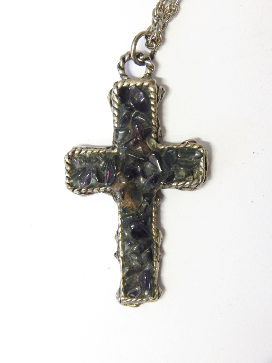 Silver-coloured cross pendant set with amethyst and other quartz,