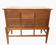 Ernest Gimson or Peter Waals oak chest on stand, the lift-up top with six raised panels,