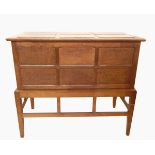Ernest Gimson or Peter Waals oak chest on stand, the lift-up top with six raised panels,