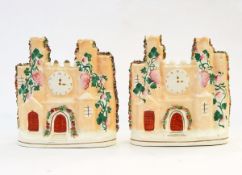 Pair of Staffordshire flatback moulded castles with floral decoration, clock,