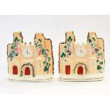 Pair of Staffordshire flatback moulded castles with floral decoration, clock,