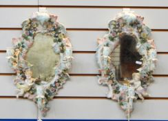 Pair of early 20th century rococo style mirrors with candle sconces, shell shaped, floral encrusted,