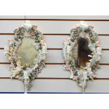 Pair of early 20th century rococo style mirrors with candle sconces, shell shaped, floral encrusted,