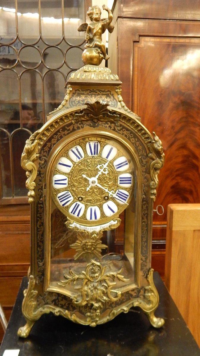 French brass inlaid and ebonised mantel clock having winged cherub finial,