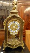 French brass inlaid and ebonised mantel clock having winged cherub finial,