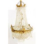 20th century brass electrolier, three-tier with graduated cut glass droplets,