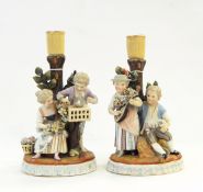 Pair early 19th century continental porcelain candlestick figure groups depicting boy and girl with