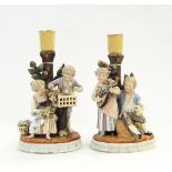 Pair early 19th century continental porcelain candlestick figure groups depicting boy and girl with