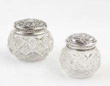 A pair of cut glass dressing table jars of compressed circular form,
