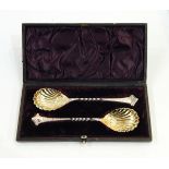 Set of six silver teaspoons and matching tongs having pierced handles and scrollwork finials,