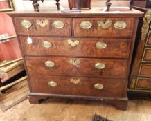 18th century figured walnut chest of two short and three long graduated drawers, ogee mould top,