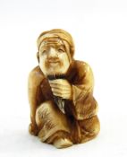 Japanese carved ivory netsuke, man seated and pulling beard (cracked), 3.