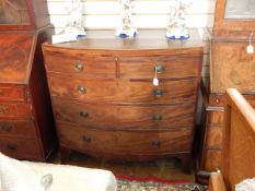 George III figured mahogany bowfronted chest of two short and three long graduated drawers,