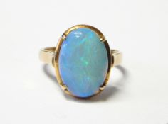 Gold and opal ring, the oval opal cabochon in four-claw setting,