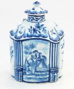 Delft blue and white tea canister of shaped oval form with central panel of an amorous couple,