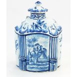 Delft blue and white tea canister of shaped oval form with central panel of an amorous couple,