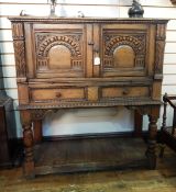 Jacobean style reproduction oak side cabinet with carved panels,