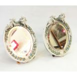 Pair of Dresden Augustus Rex porcelain oval easel mirrors with classical moulded borders surmounted