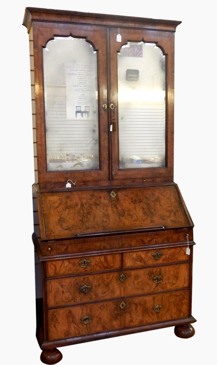 Queen Anne figured walnut bureau bookcase with cavetto pediment, mirrored panel doors,