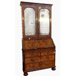 Queen Anne figured walnut bureau bookcase with cavetto pediment, mirrored panel doors,