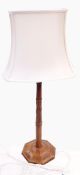 Gimson walnut table lamp having tapered and ring turned octagonal column with lozenge faceted