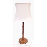 Gimson walnut table lamp having tapered and ring turned octagonal column with lozenge faceted