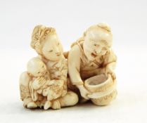 Japanese carved ivory netsuke, husband and wife with baby, signed,