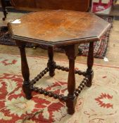 Oak octagonal occasional table with baluster-shaped supports and bobbin turned stretchers,