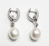 Pair of 18ct white gold pearl and diamond earrings,