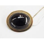 Gold and agate brooch, the oval banded agate cabochon set in a gold mount with ropetwist decoration,