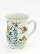 Two Chinese graduated porcelain mugs each painted with crabs within a fence and flowers and fruit,