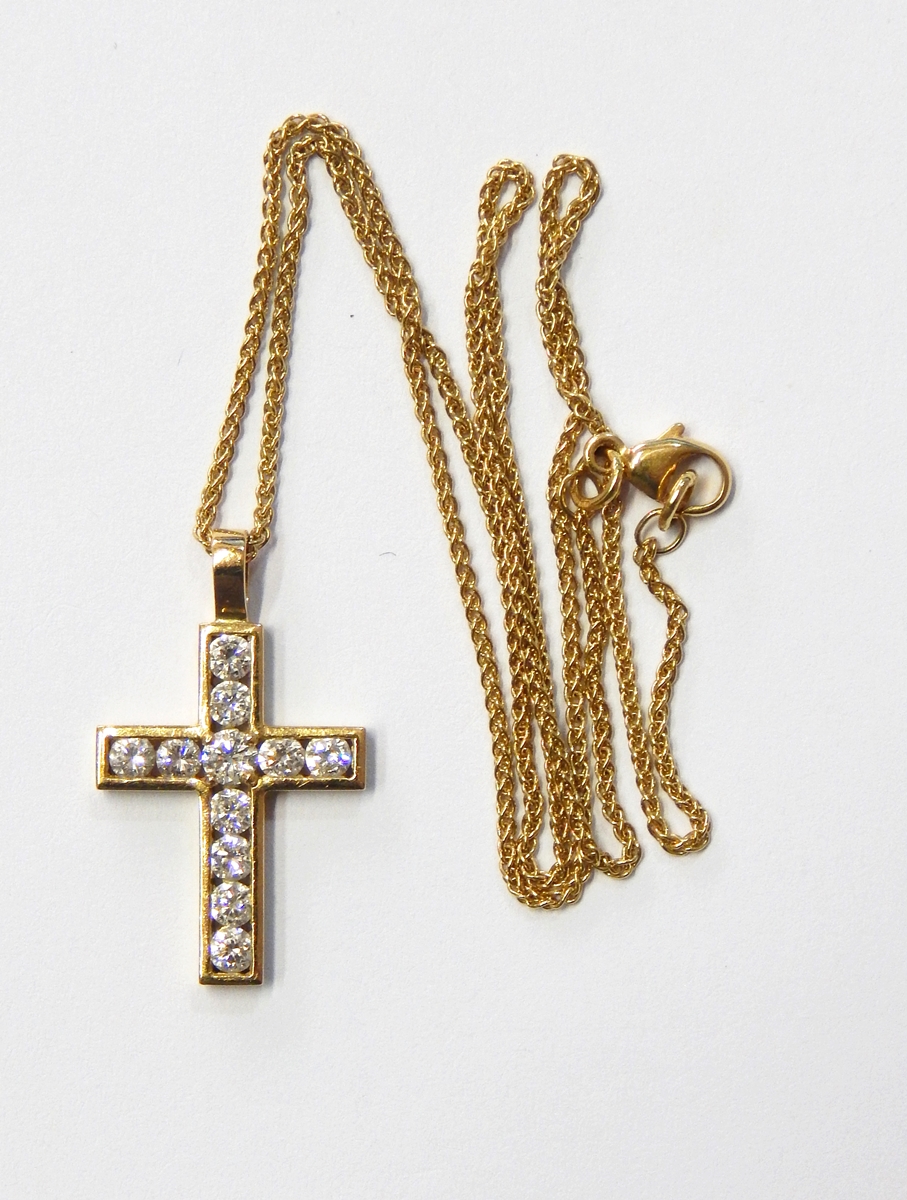 18ct gold and diamond cross pendant, the central diamond approx. 0.