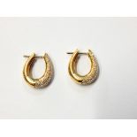 Pair 18ct gold and diamond earrings, each oval hoop,