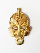 Gold pendant modelled as a mask with filigree decoration,