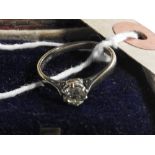 An 18ct white gold solitaire diamond ring in a Tiffany style setting (diamond approx .