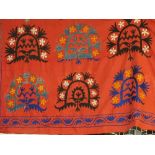 A large late 19th century Uzbekistan Sozani wall hanging, red ground with repeating turquoise,