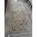 A hand knotted woollen and silk carpet with floral decoration on biscuit field, 255cm x 165cm.