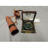 A 20th century walnut Spencer and Co magnifying glass, along with a leather cased telescope (2)