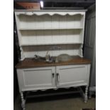 A white painted dresser with open shelves over panel doors, 170cm x 137cm x 53cm.