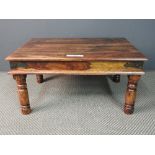 A Contemporary colonial style teak low coffee table, brass bound on round supports 83cm(L) 63cm(W)