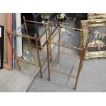 A pair of early 20th Century brass and glass two tiered whatnots/occasional tables with acorn