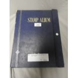 A cased stamp album, enclosing stamps from across the globe