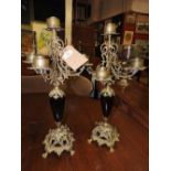 A pair of brass classical style five branch candelabra with a blue glass stem