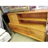 A 1970s G-plan style teak cabinet/sideboard, the upper shelf above two drawers flanked by cupboard