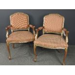 A pair of gilt French style fauteuils, the red and yellow striped upholstered seats on cabriole